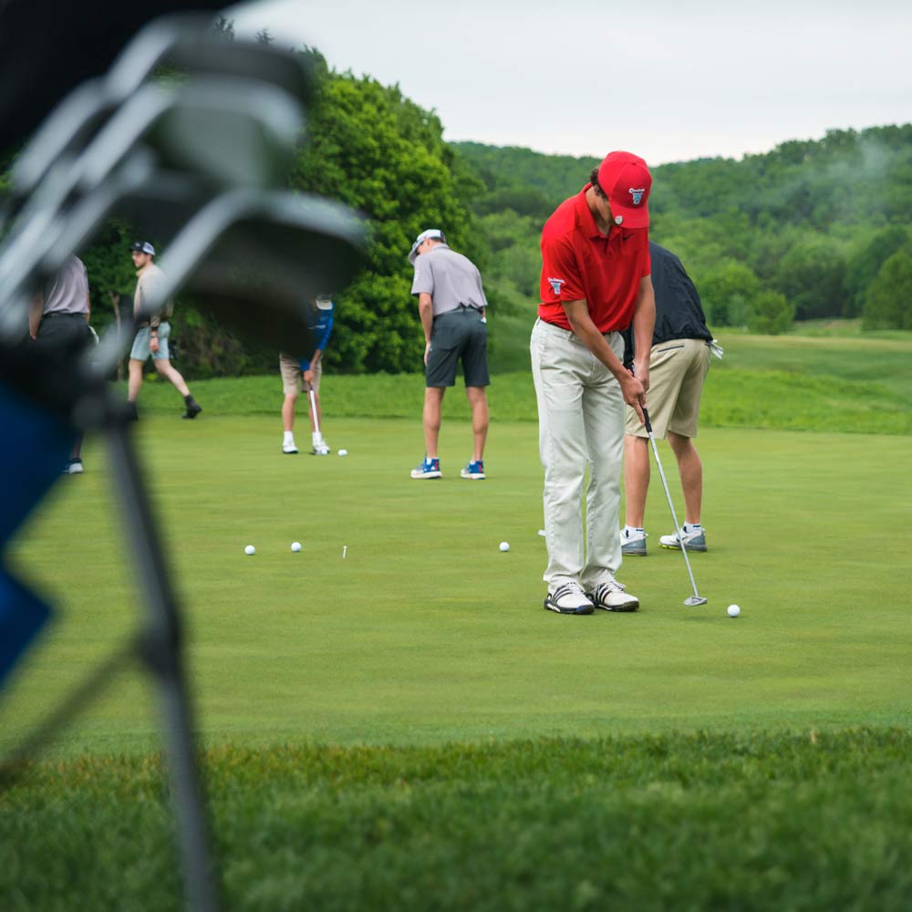 guests practicing on the putting green at Old Kinderhook golf course